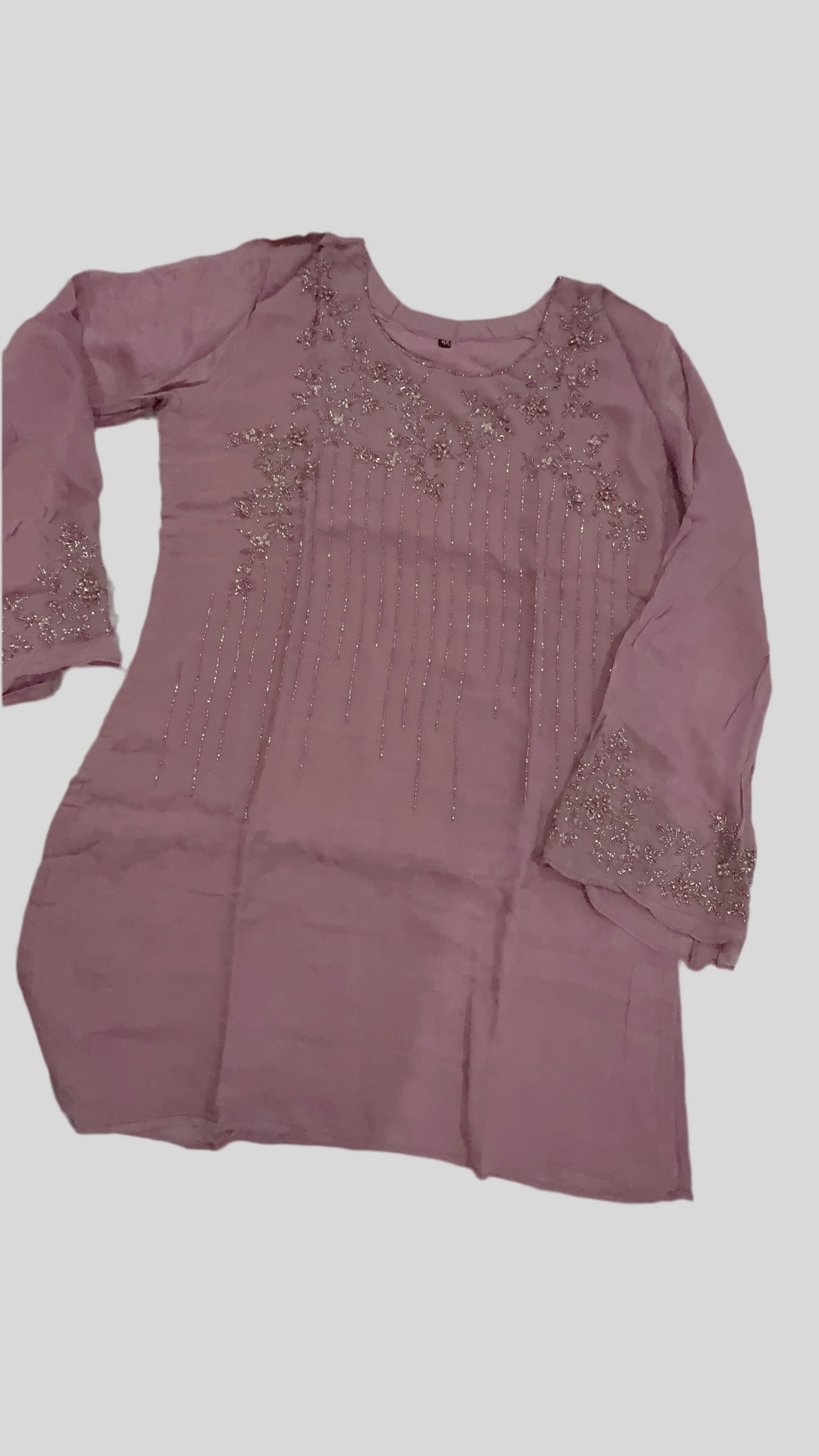 Mauve dress with bead embellishments on a light gray background