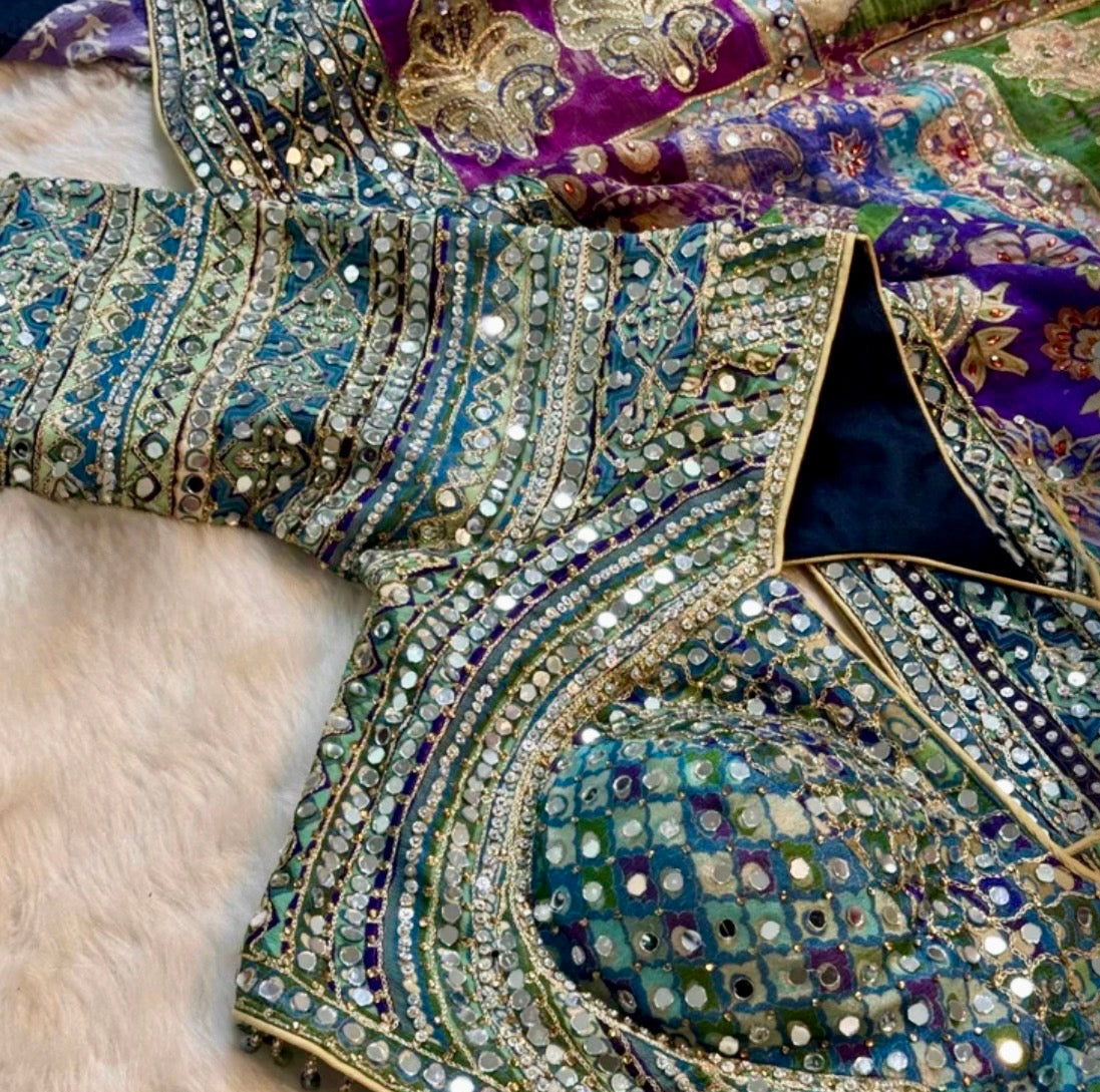 Close-up of an intricately designed garment with embroidery and embellishments.