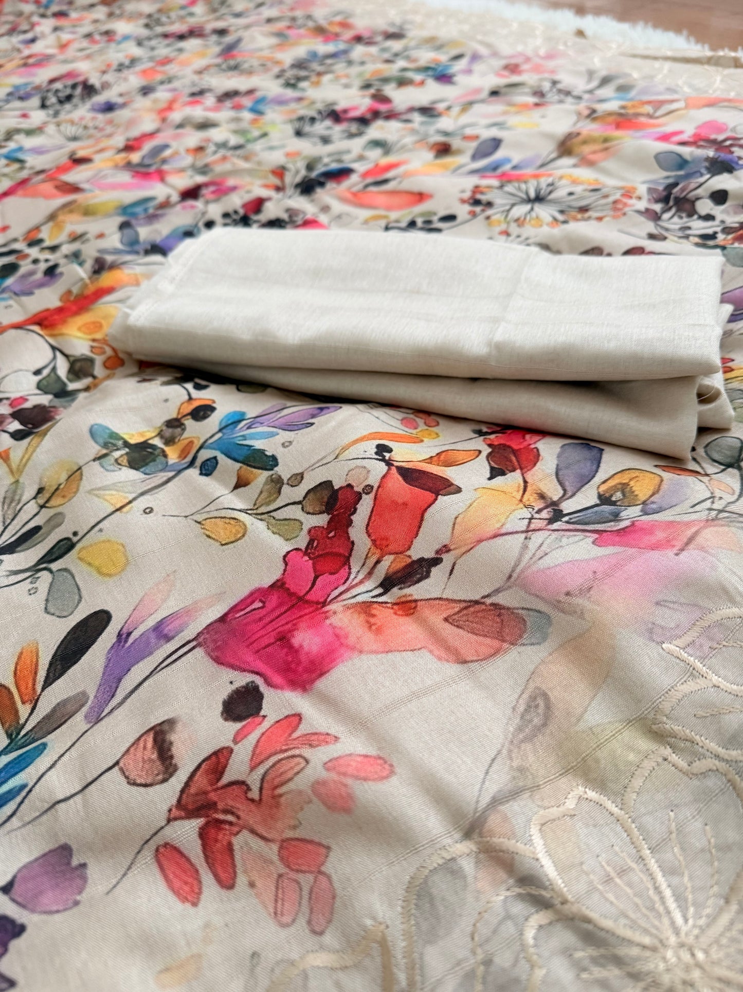 Close-up of fabric with floral patterns and neutral colors.