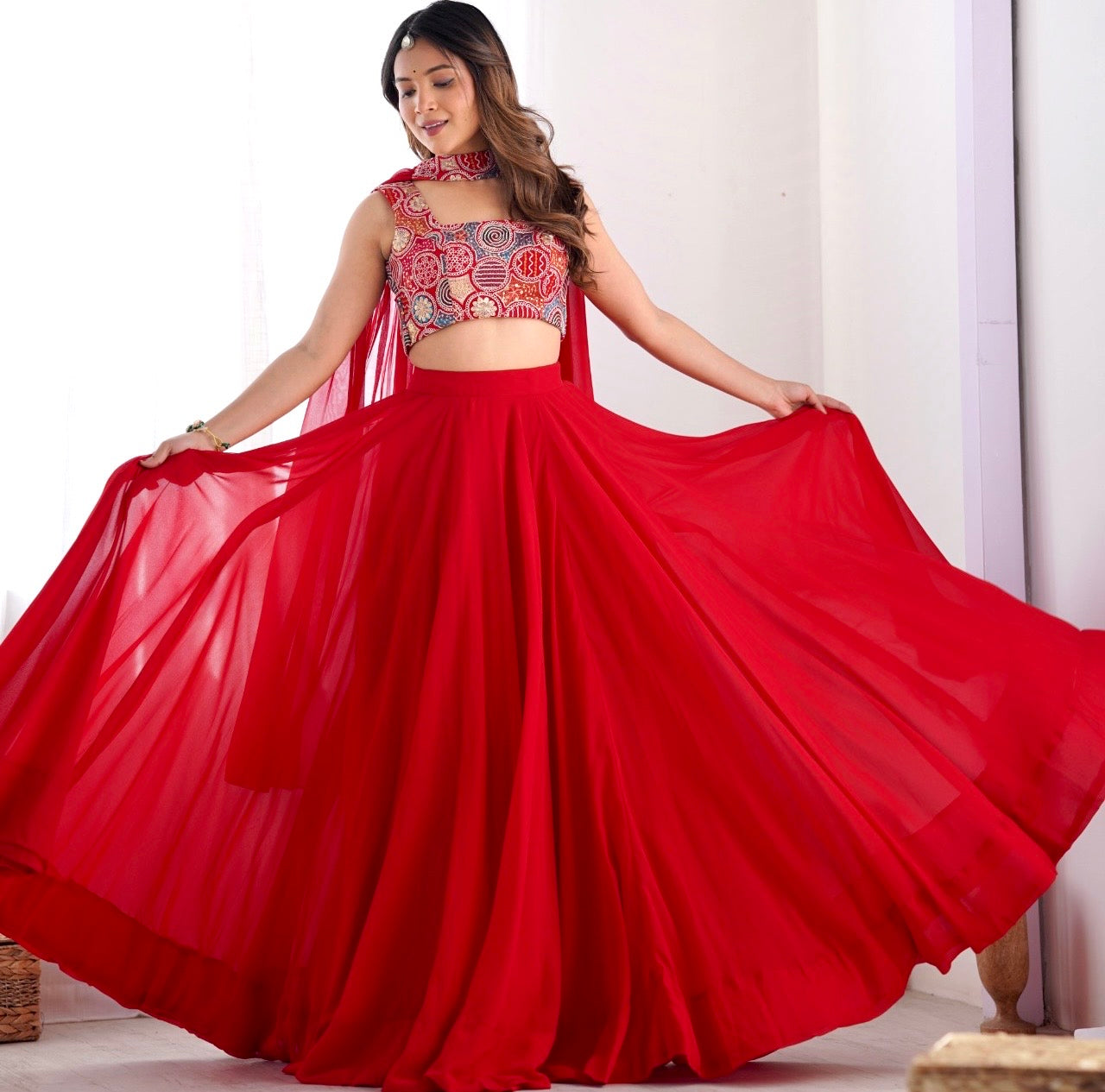 Woman wearing a red traditional outfit with a flowing skirt on a white background