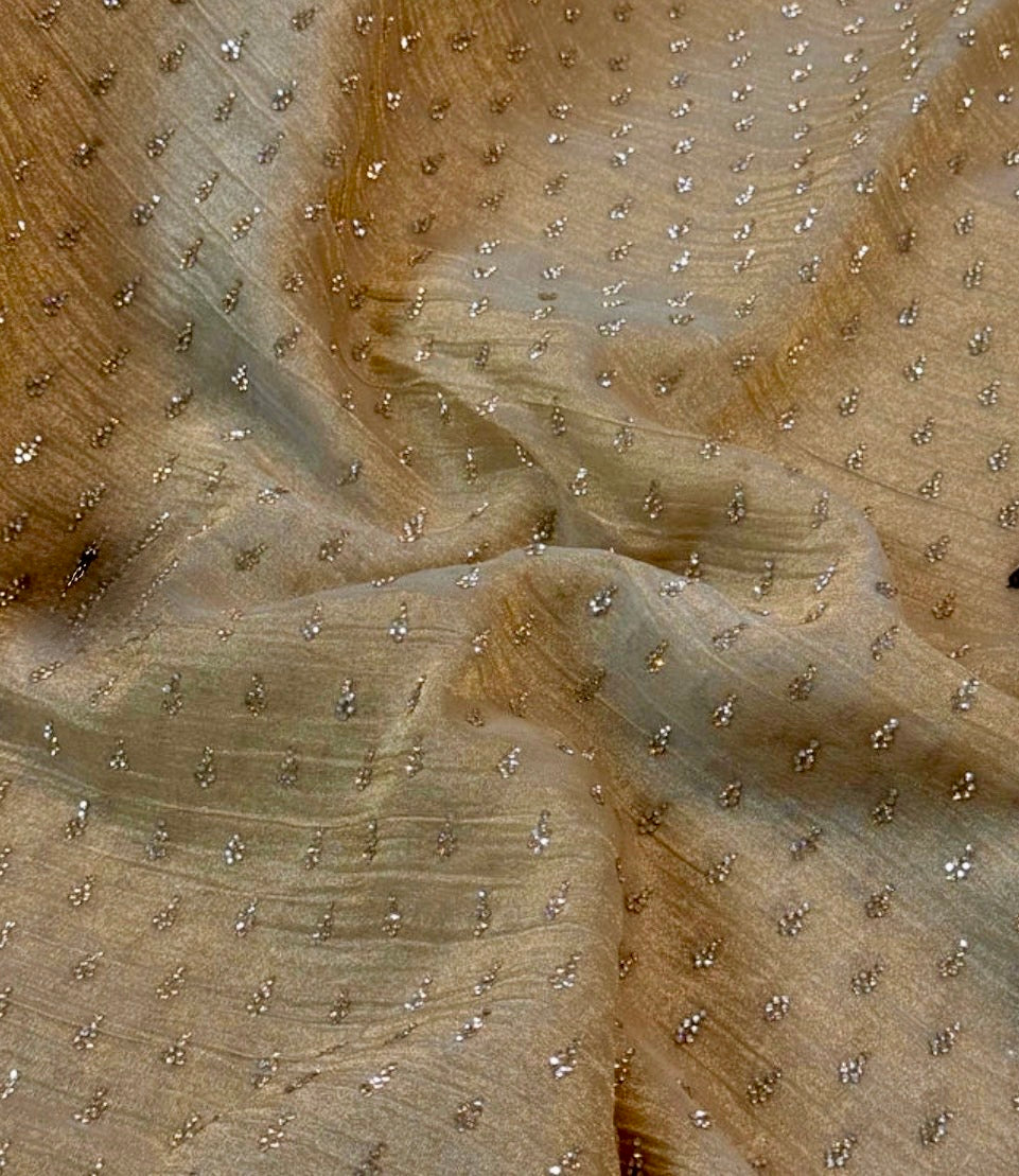 Close-up of beige fabric with small embellishments