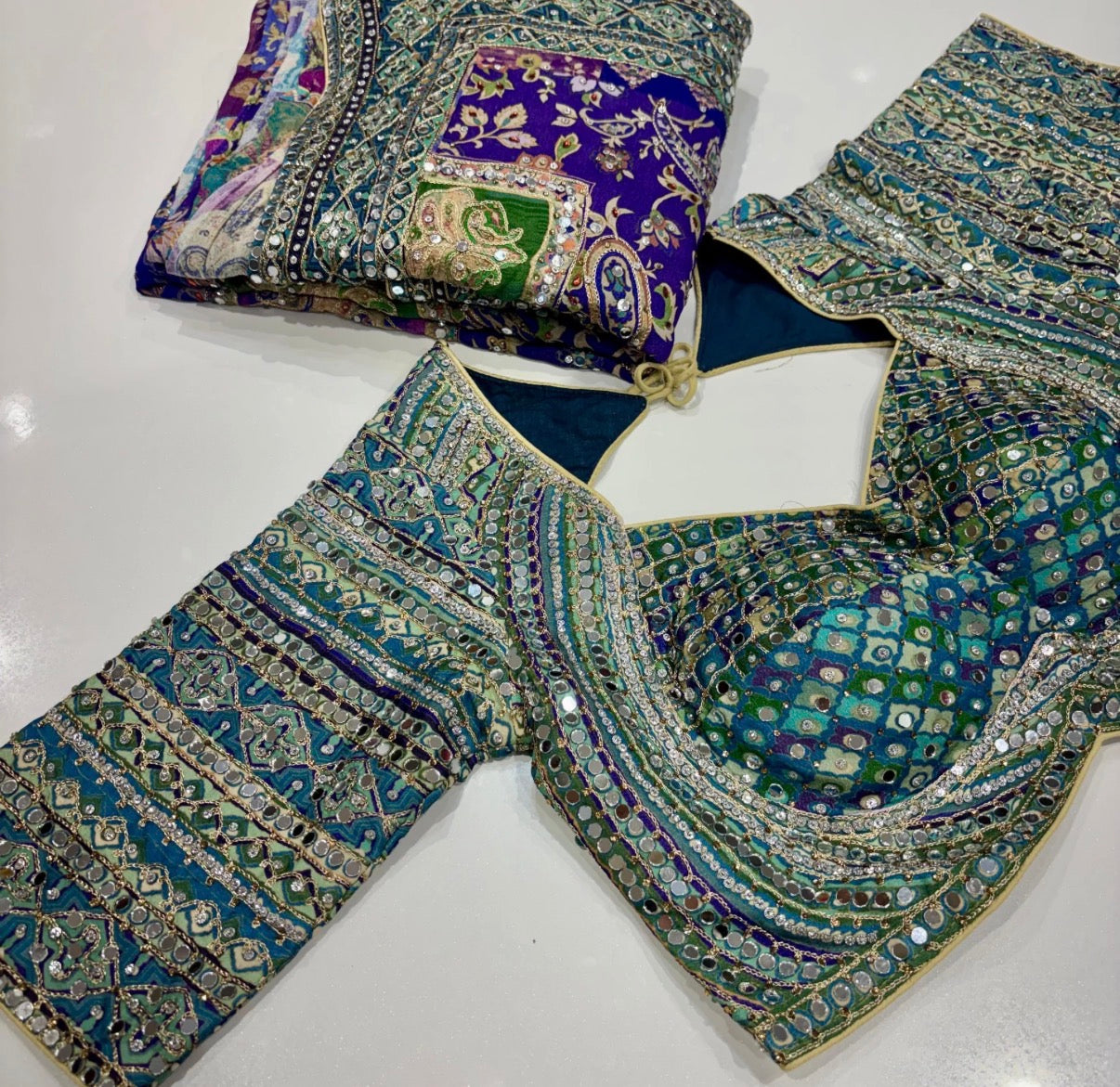 Embroidered fabric with intricate patterns on a white surface