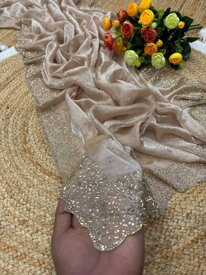 Beige fabric with floral embellishments on a textured surface