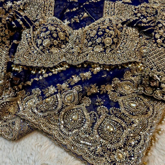 Close-up of intricate gold embroidery on a dark fabric background