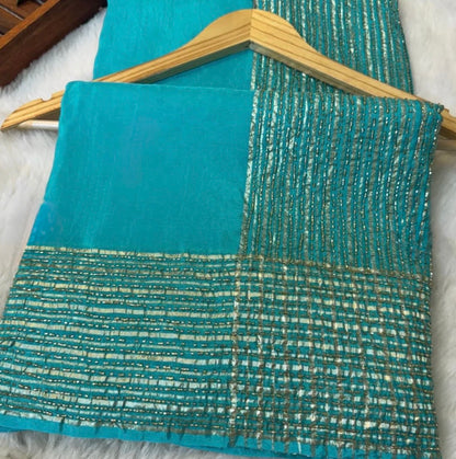 Teal fabric with gold thread pattern on a wooden hanger