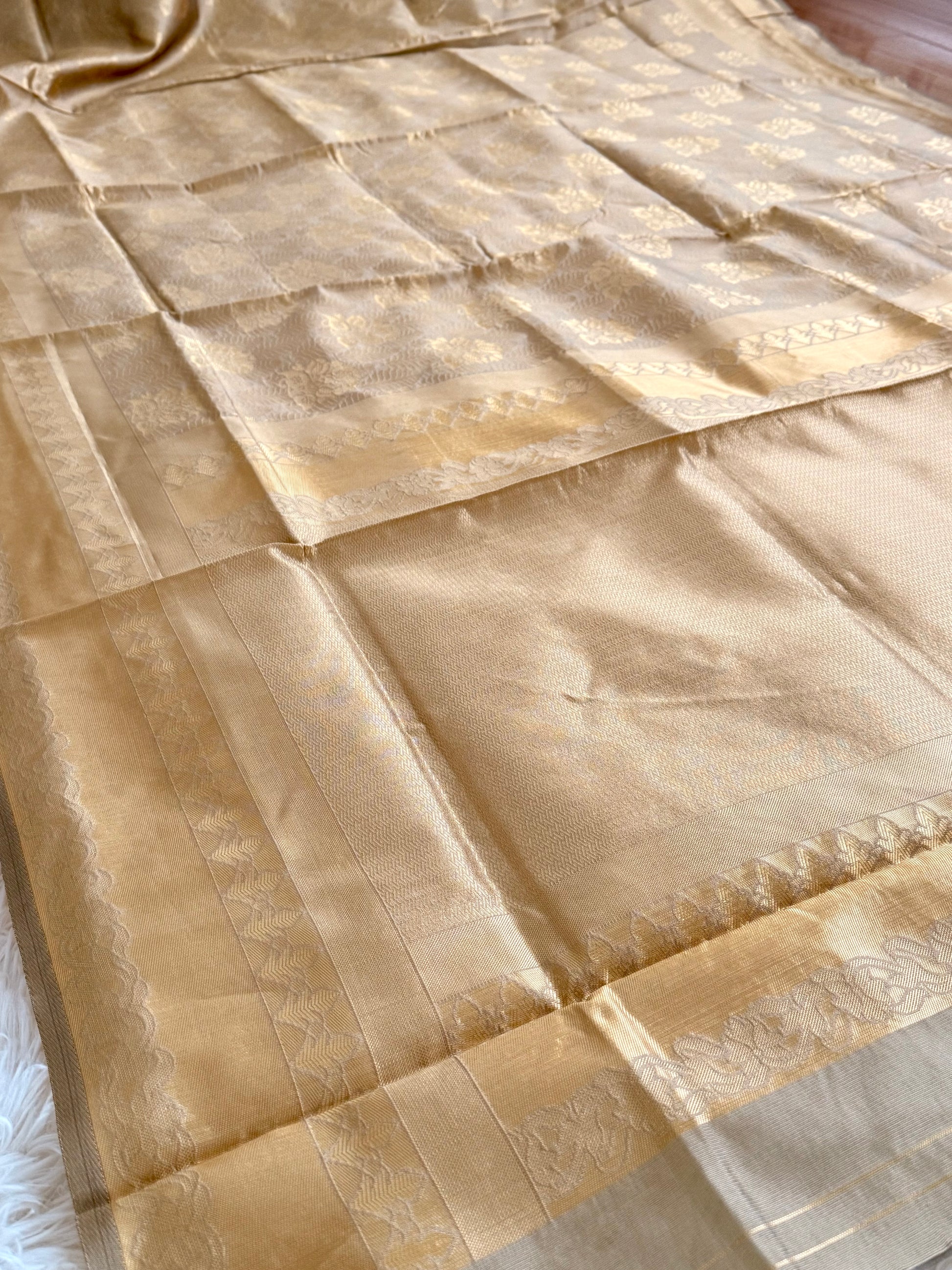 Beige fabric with gold embroidery on a white background