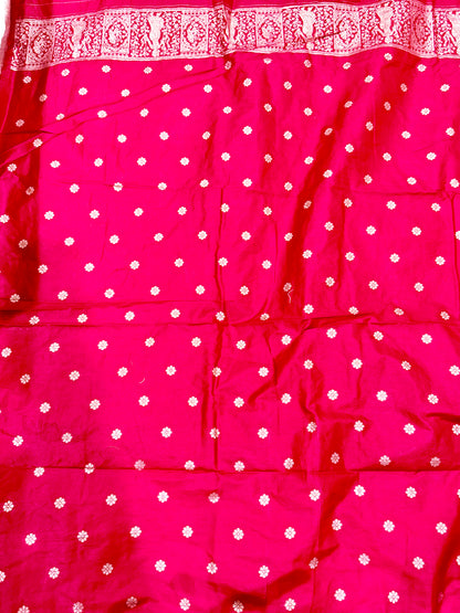Pink fabric with white polka dots and a decorative border