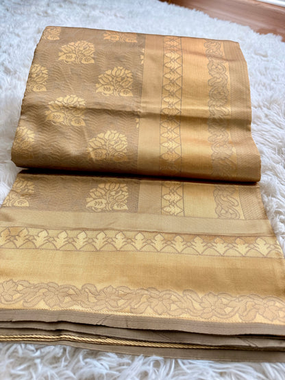 Folded brown fabric with intricate patterns on a white textured surface
