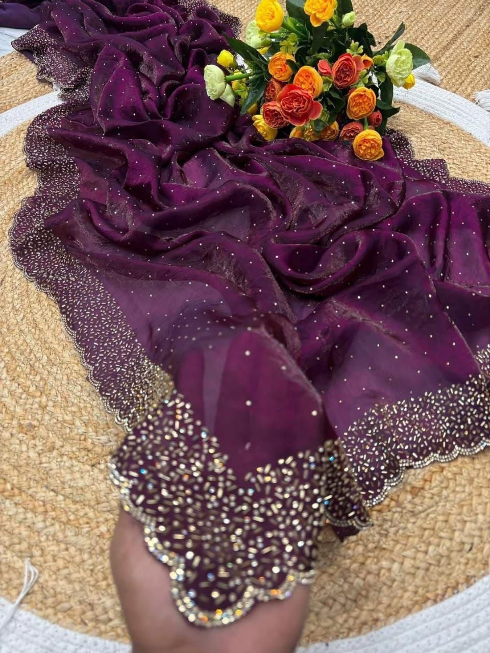 Purple floral dress with glittery details on a textured surface