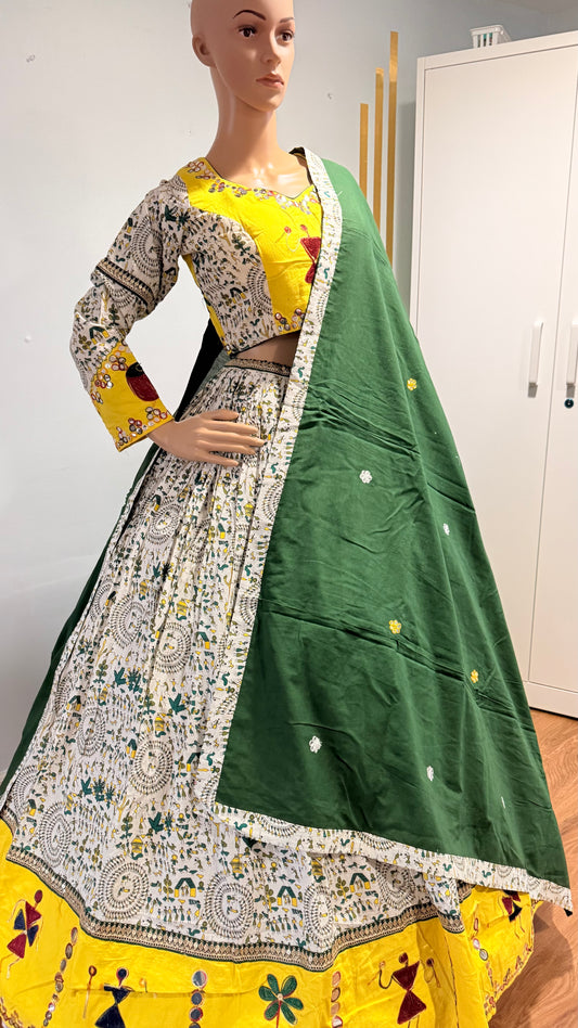 Mannequin wearing a traditional outfit with a green dupatta and yellow and white top.