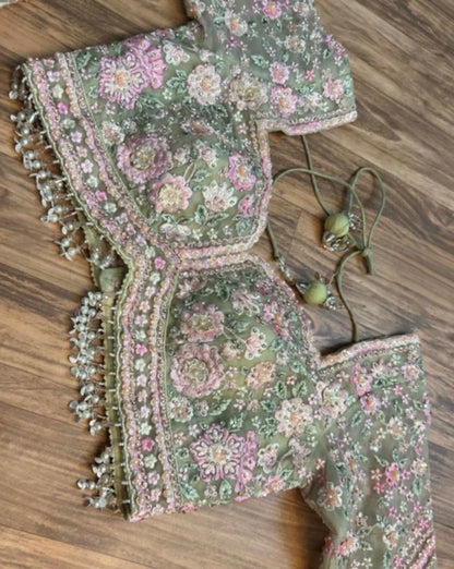 Traditional embroidered garment with floral patterns on a wooden surface