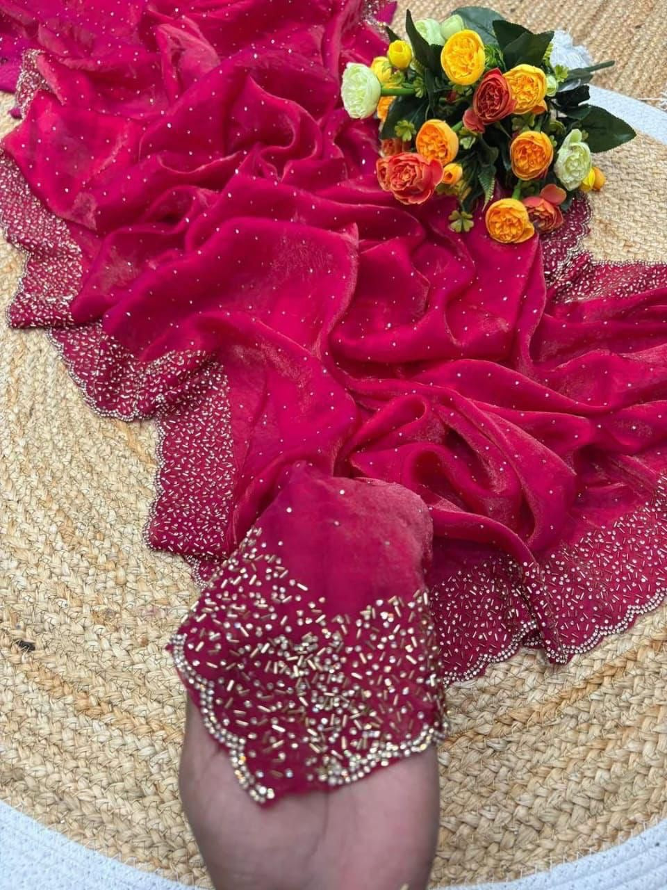 Pink fabric with floral arrangement on a textured surface