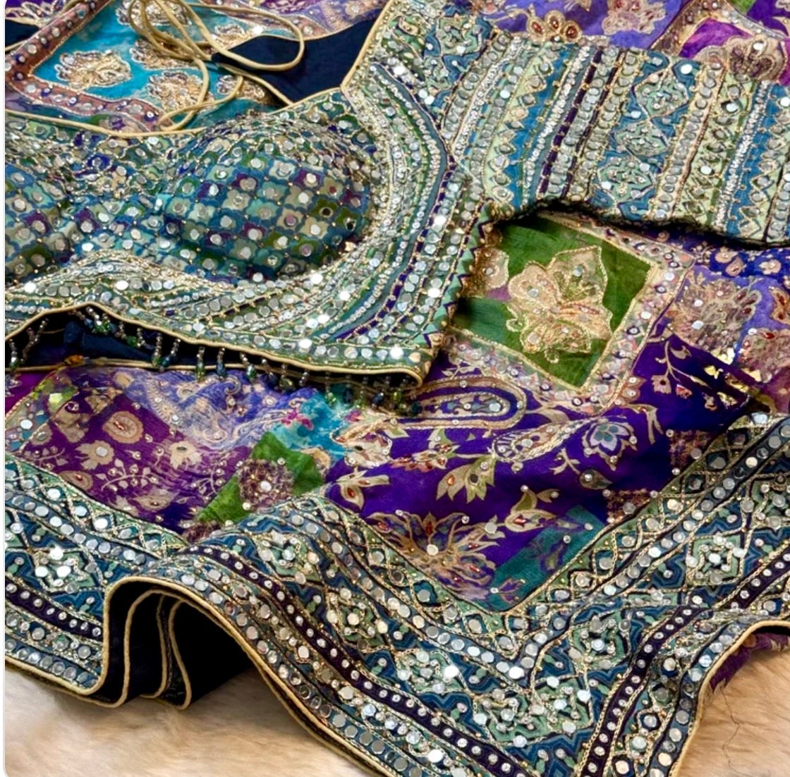Decorative fabric with intricate patterns and embellishments on a wooden surface
