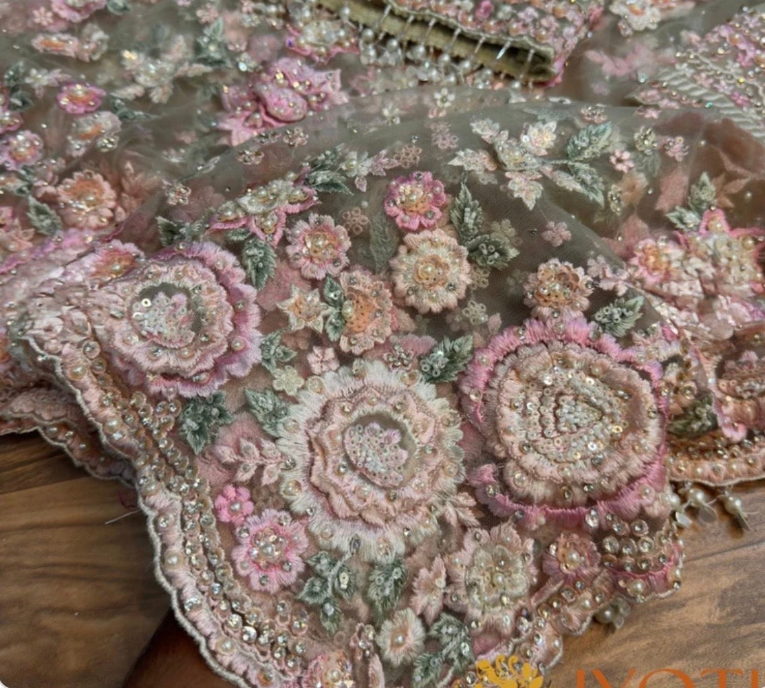 Close-up of embroidered fabric with floral patterns on a wooden surface