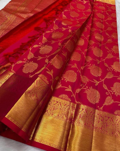 Red saree with gold floral patterns on a white background