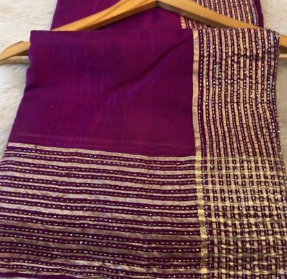 Purple fabric with patterned border on a wooden hanger