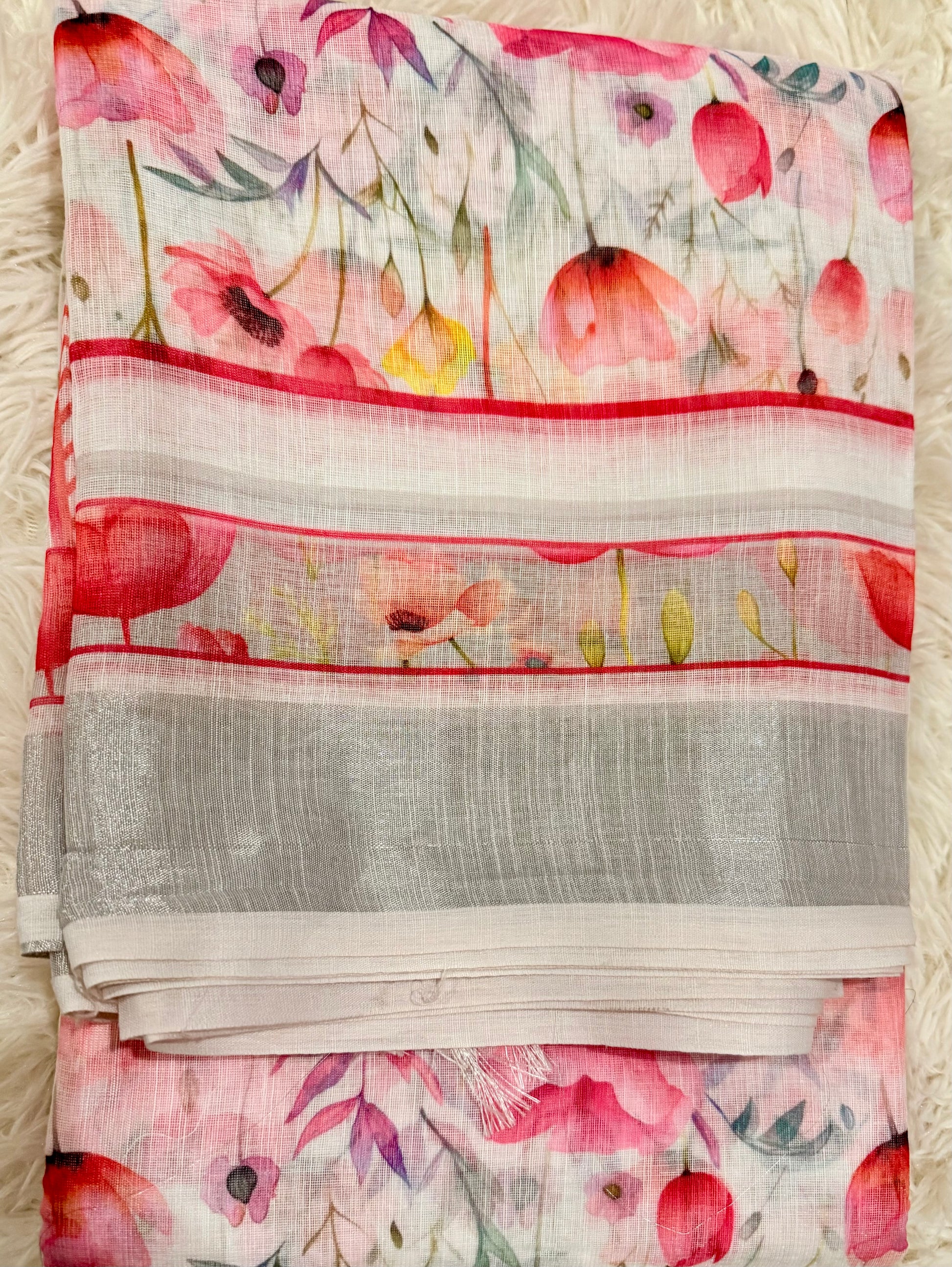 Floral patterned fabric with red and pink flowers on a white background