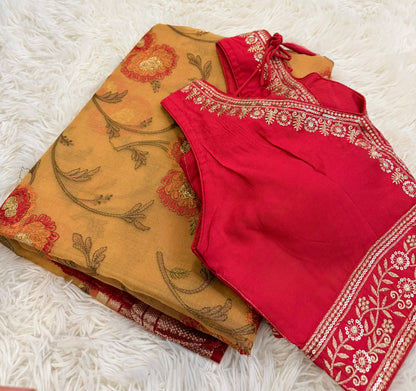 Red and beige traditional outfits with floral patterns on a white textured surface