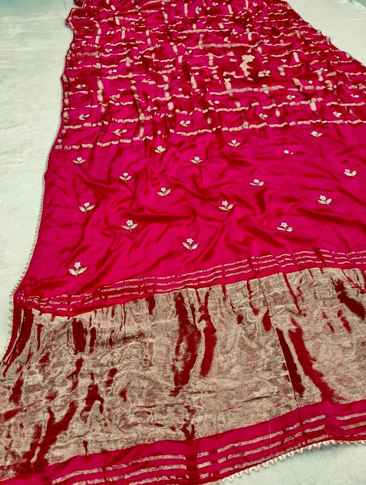 Red and gold patterned fabric on a white background