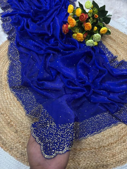 Blue fabric with gold trim and a bouquet of flowers on a textured surface