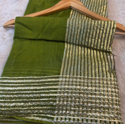 Green fabric with gold and silver pattern on a wooden hanger
