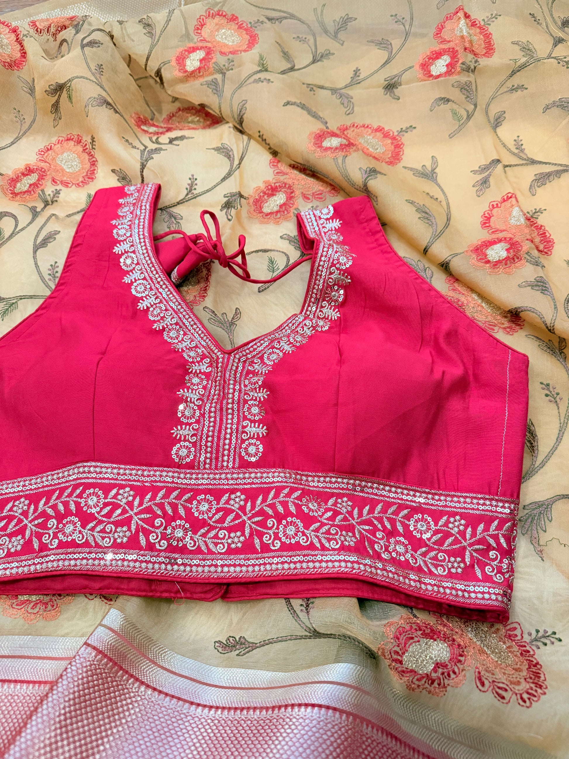 Red embroidered blouse on a floral fabric background