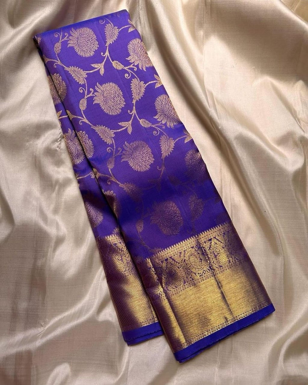 Purple and gold traditional fabric on a white fabric background
