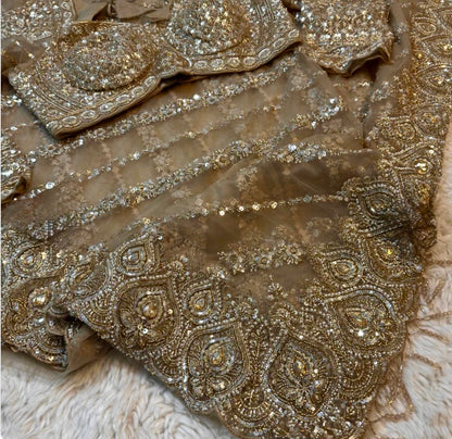 Close-up of embroidered fabric with intricate patterns and embellishments.