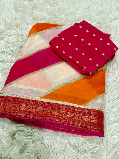 Colorful saree with a pink blouse on a white textured surface