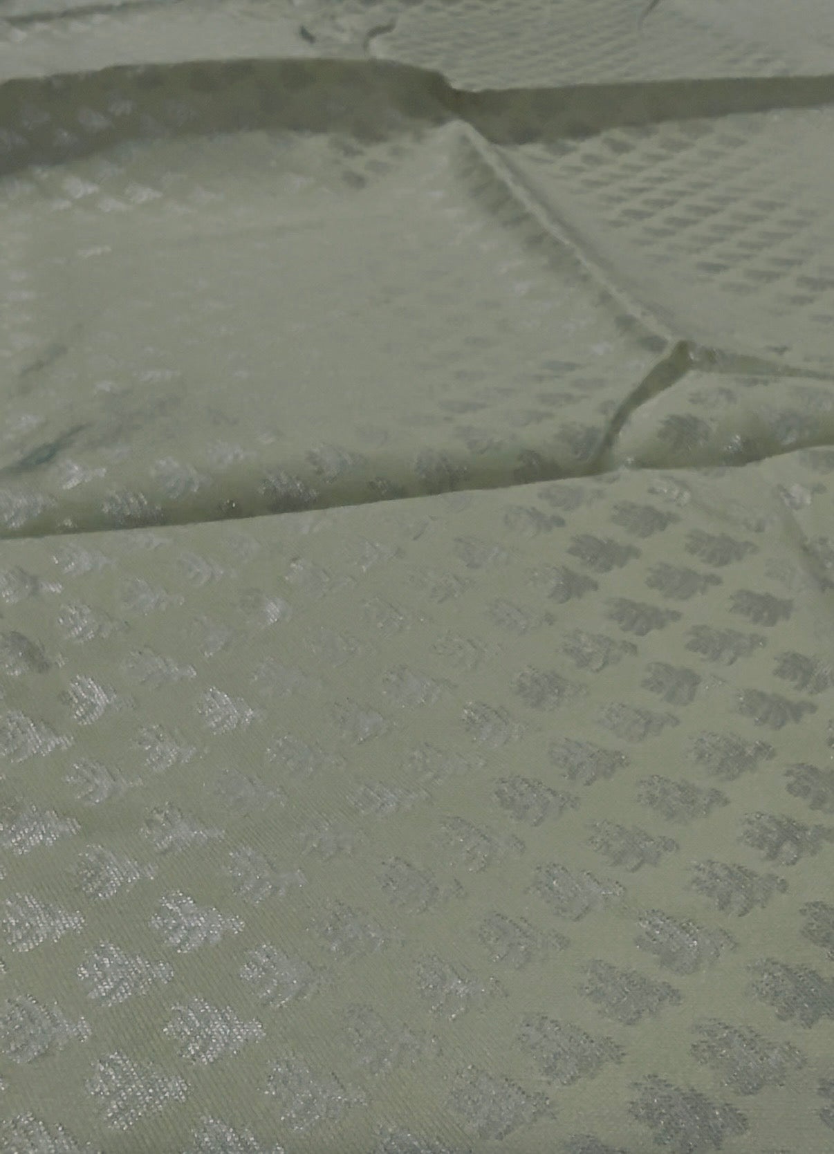 Green fabric with a subtle pattern on a green background