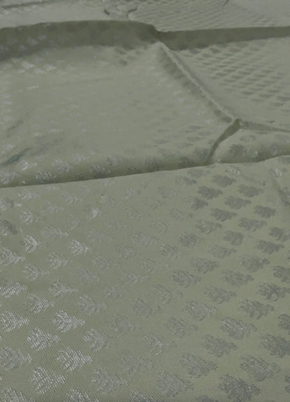 Green fabric with a subtle pattern on a green background