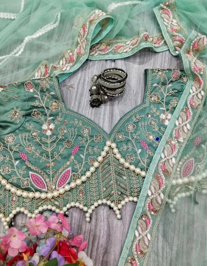 Latest Bollywood Style Pastel Green Embroidered Blouse with Pearl Detailing and Premium
Net Saree