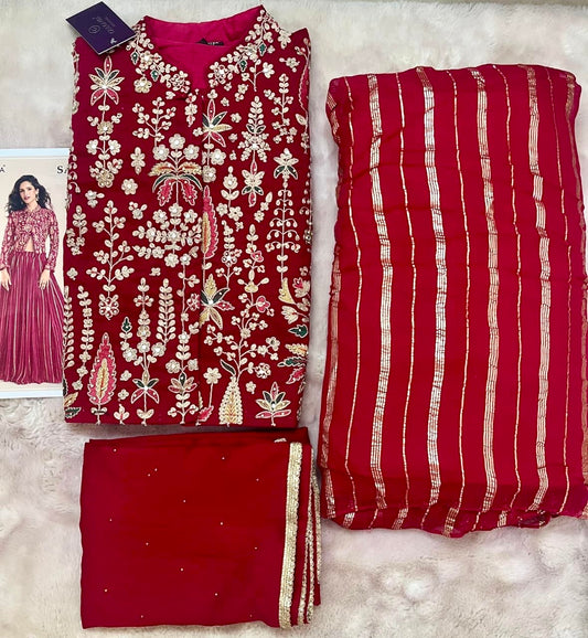 Red embroidered fabric with striped fabric on a white background