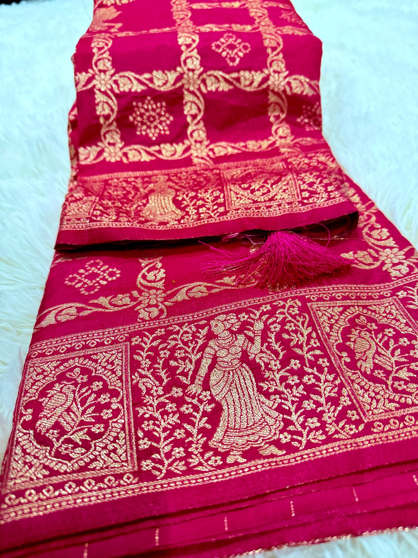 Pink saree with gold embroidery on a white background