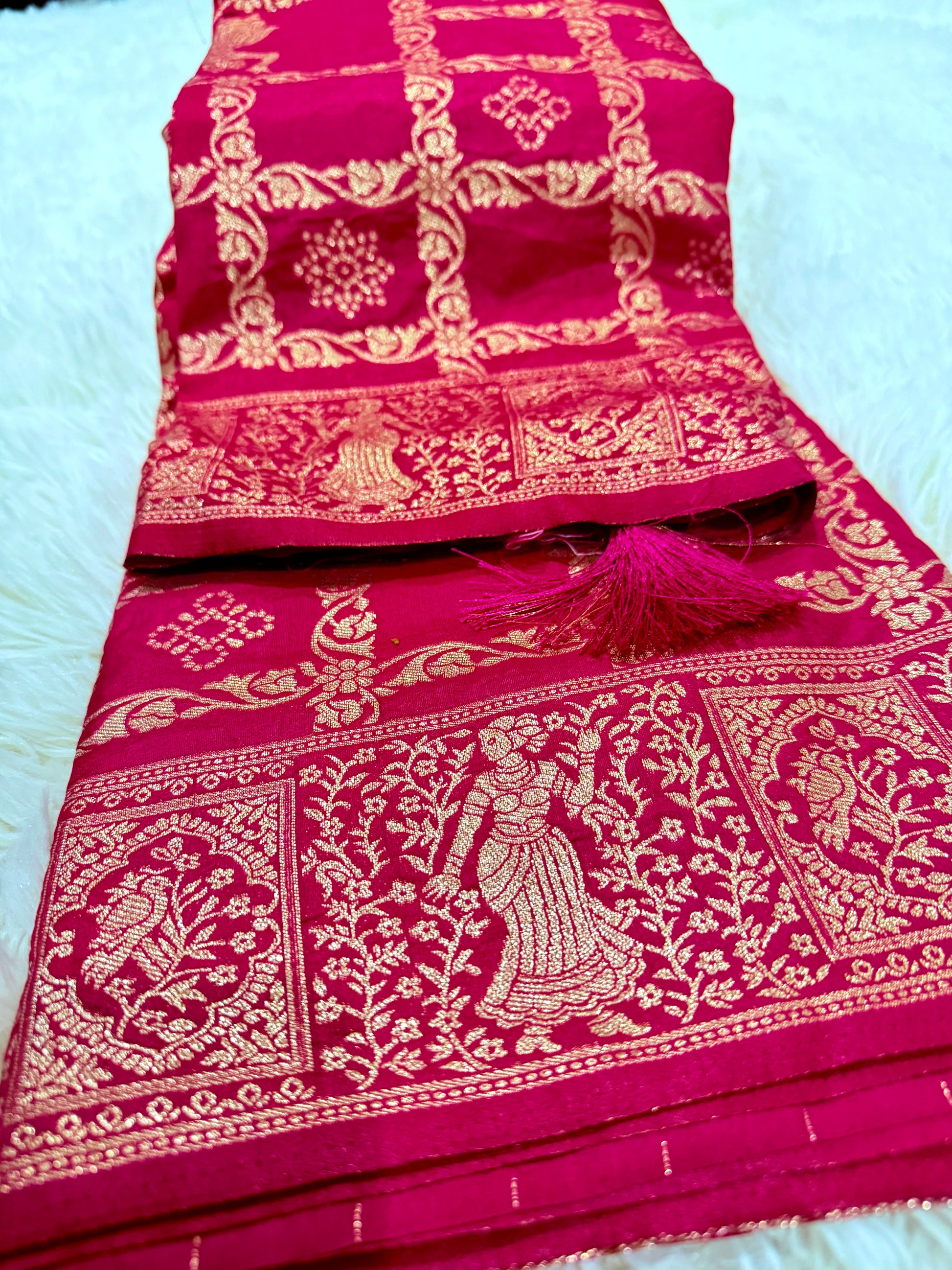 Pink saree with gold embroidery on a white background