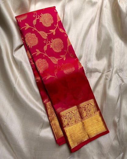 Red saree with gold floral patterns on a white fabric background