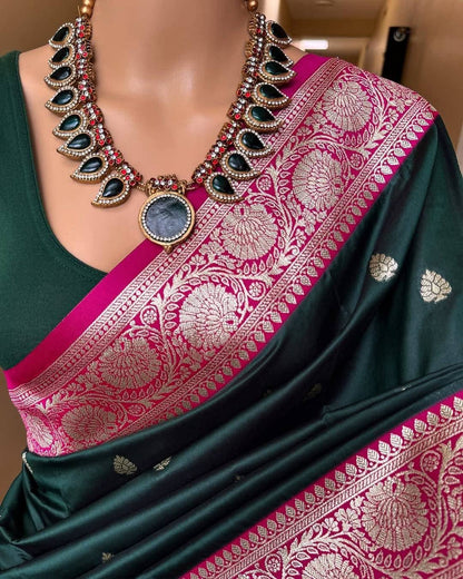 Green saree with pink border and necklace on a mannequin