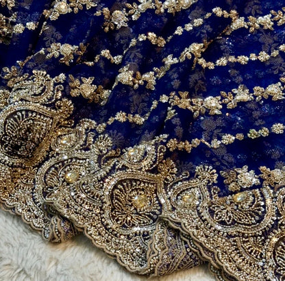 Close-up of intricate gold embroidery on blue fabric