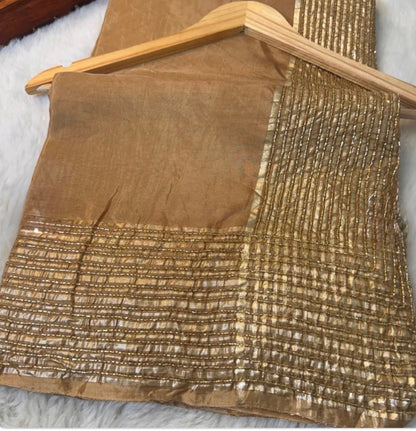 Brown fabric with textured pattern on a wooden hanger against a white background