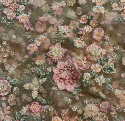 Close-up of floral fabric with pink and green flowers on a brown background