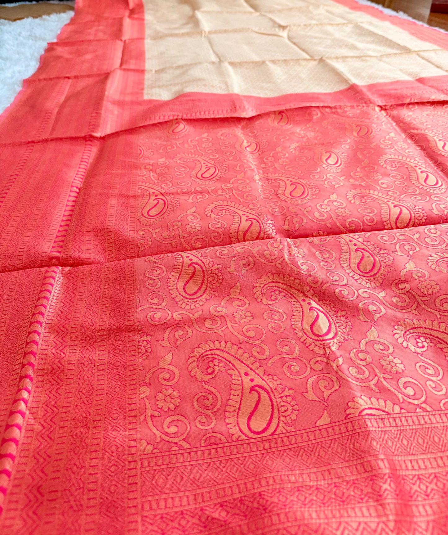 Pink saree with a subtle pattern on a plain background