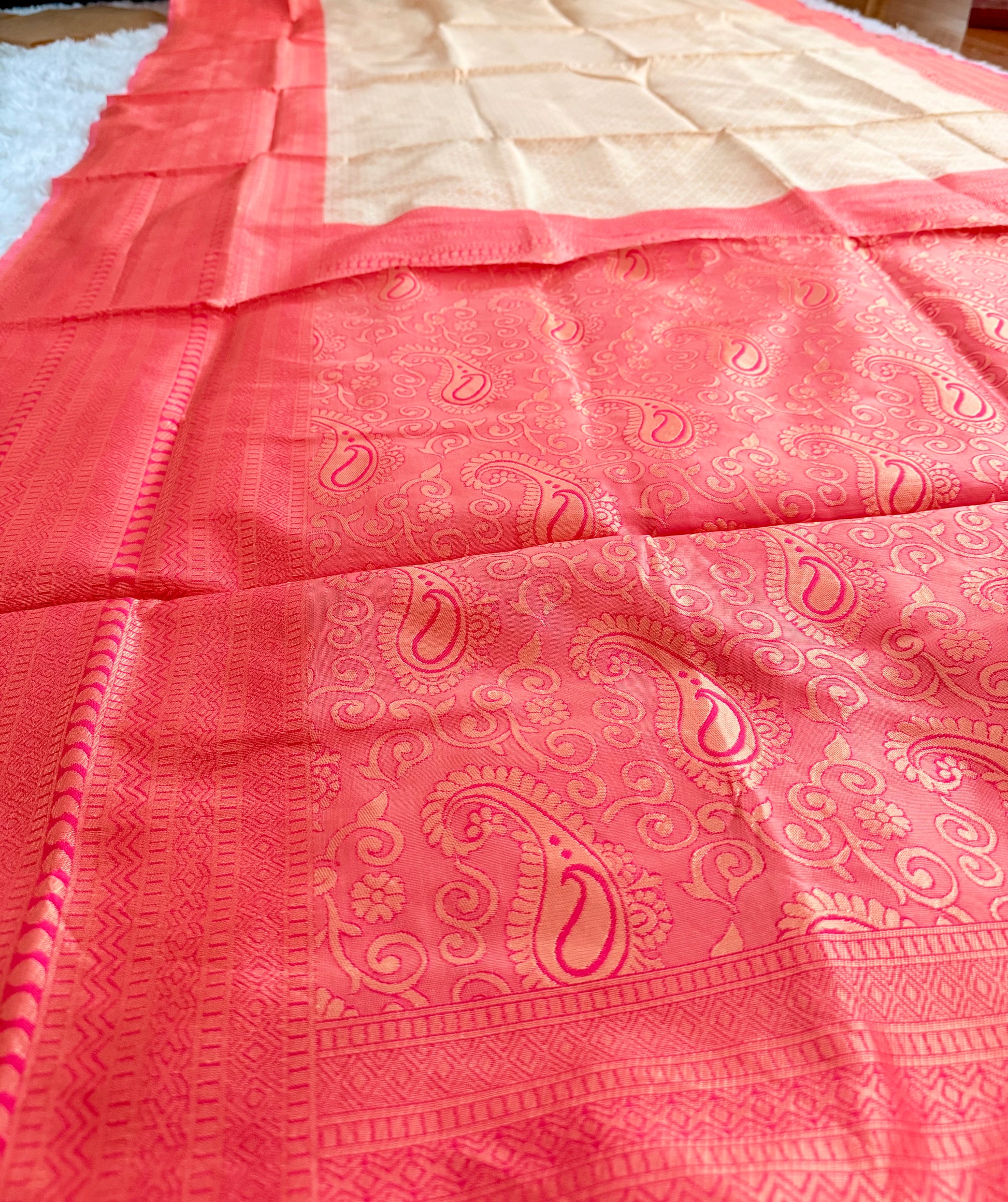 Pink saree with a subtle pattern on a plain background