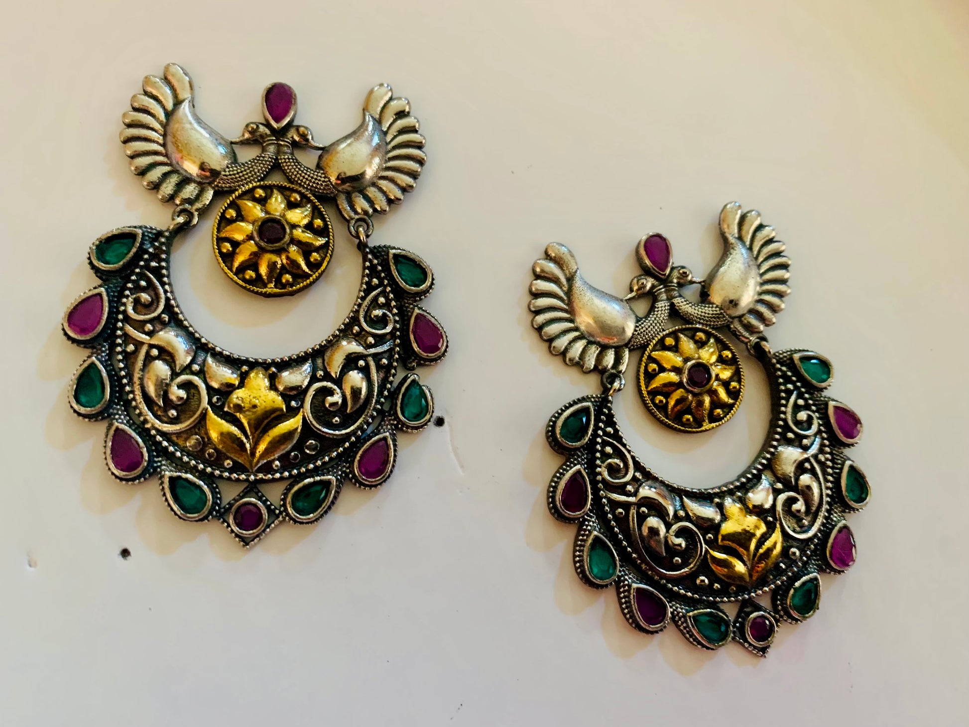 ornate earrings featuring a dual tone purple-green color scheme with gold-colored accents.