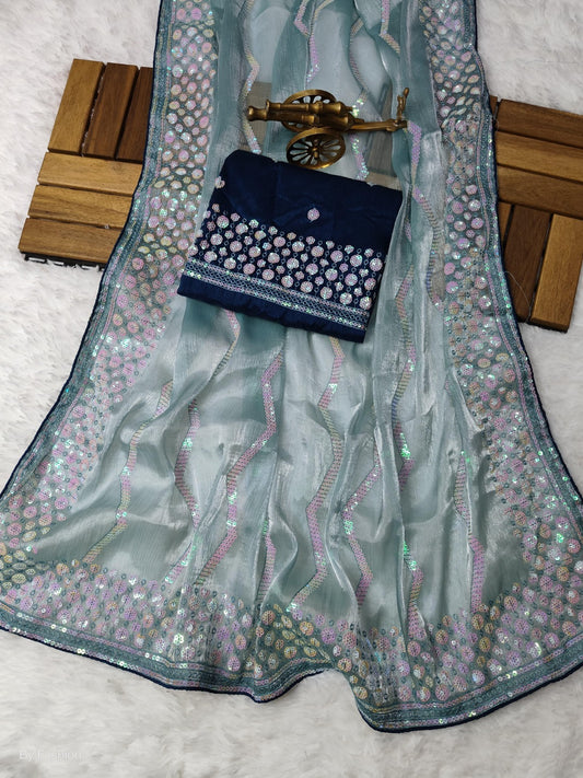 Light blue embroidered fabric with a dark blue embroidered pouch on a light gray background